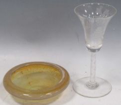 A wine glass with an engraved trumpet bowl, on an air-twist stem, 17cm high; an amber-coloured glass