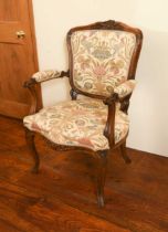 A reproduction French open armchair