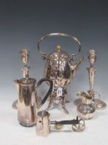 A collection of sliver plated items including kettle, candlesticks, sauce boats, breadbasket,