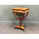 A Regency flame mahogany work table, the hinged lid enclosing a fitted interior on lion paw feet