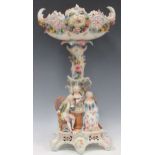 An early 20th century continental porcelain fruit stand, the base with figures playing chess, 54cm