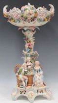 An early 20th century continental porcelain fruit stand, the base with figures playing chess, 54cm