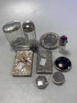 A silver card case, a mother of pearl card case, two silver pill boxes, a silver and tortoiseshell