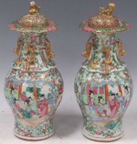 A pair of Chinese, early 20th century, Canton vases and covers, 27cm high Fading to the gilt and