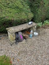 A composite stone garden bench with rectangular seat raised on mould squirrel supports; together