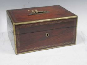 A 19th century rosewood and brass bound vanity travelling case with fitted interior and some cut