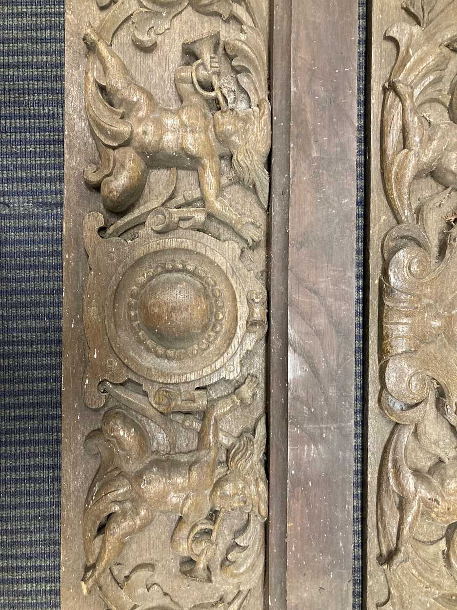 Two 19th century carved oak panels, each with a central cartouche flanked by cherubs and scrolling - Image 2 of 4