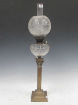 A brass column table lamp with cut glass font and etched shade, 84cm high