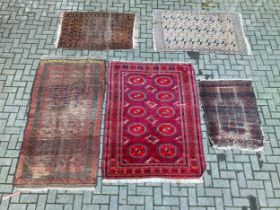 Two Tekke Turkmen rugs together with three Beluchi rugs; 200 x 98cm, 179 x 128cm, 106 x 74cm, 156