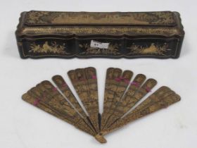 A Chinese 19th century black lacquer fan box, and a small painted stick fan, 9 x 36 x 9cm Cracking