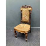 A Victorian carved walnut lady's chair, with floral needlework upholstery, on cabriole legs