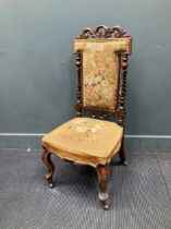 A Victorian carved walnut lady's chair, with floral needlework upholstery, on cabriole legs