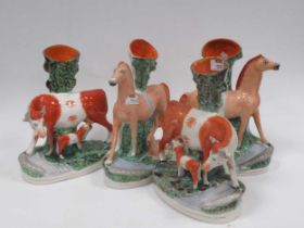 Staffordshire figures. Two horse and foal groups, and cow and calf groups (4) Crazing to the glaze