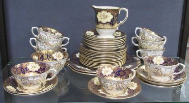 A Crown Staffordshire tea service, decorated with flowers, comprising teacups, a sugar bowl, milk