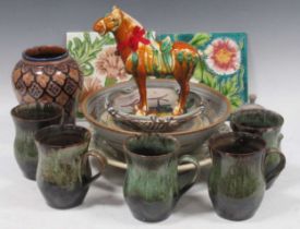 A collection of various studio ceramics, including tankards, bowls, plates, a modern Tang-style