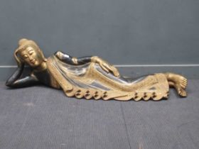 A carved wooden Buddha retailed by Liberty's of London Sizes approx 40 x 154 x 36cm. Fading to the