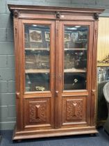 A Dutch oak cupboard by Pander, circa 1900, the moulded cornice above three carved lion masks,