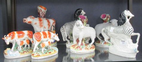 Staffordshire figures. Pairs of zebras, sheep and cow with calf groups, and cow spill vase (7)