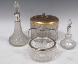 Two silver-mounted dressing table scent bottles, a cut glass gilt metal lidded biscuit box, and a