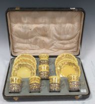 A Coalport porcelain set of six yellow ground and gilt decorated coffee cups and saucers, each cup