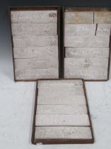 Eighteen plaster low relief plaques depicting Greek historic scenes in three wooden trays