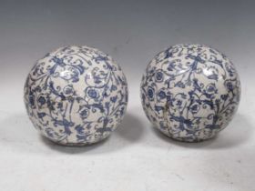 A pair of Continental blue and white transfer printed ceramic balls, 17cm diameter approximately