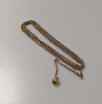 A long guard chain, with a ball charm, tested as 9ct gold, gross weight 31.2g