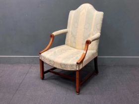 A George III style inlaid mahogany Gainsborough armchair on castors