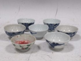 Seven Chinese porcelain tea bowls comprising six blue and white examples and a polychrome example,