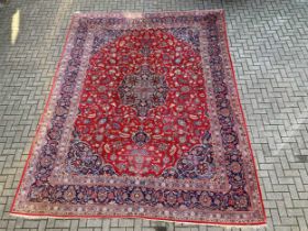 A red Persian rug decorated with flowers