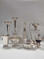 A collection of silverware including a pair of vases, a claret jug, a decanter a rose bowl a tea