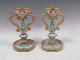 A pair of Maiolica candlesticks, 23cm high Severe chipping throughout. Both are structurally