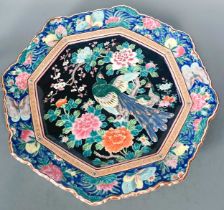 An octagonal Japanese charger the central field is decorated with a pair of peacocks, 47cm diameter