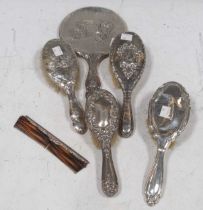 A collection of four silver hairbrushes, together with hand mirror and comb