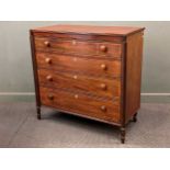 A 19th century flame mahogany chest of four long graduating drawers with bone escutcheons and spiral
