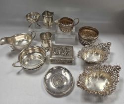 A collection of silverware including a cased cruet set, cigarette box, sauce boat, milk jug, sugar