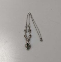 A white metal emerald and diamond necklace, centrepiece tested as 9ct gold and the chain is