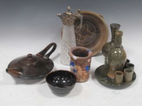 A collection of various ceramics and stone items, including a stone shot tray with bottle and shot