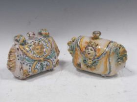 A near pair of Maiolica satchel form flagons, 14 x 20 x 8cm Severe chipping throughout, and hairline