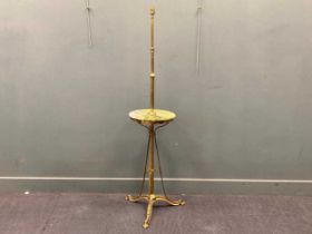 An Edwardian adjustable brass table lamp, with circular green stone tier above a tripod base 160cm