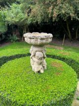 A late 20th century composite birdbath a leaf moulded bowl supported by cherubs, 97 x 48cm