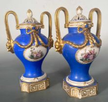 A pair of Dresden two-handeld vases and covers, painted with scenes of courting couples reserved