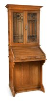 An Arts & Crafts oak roll-top bureau bookcase by Lebus,