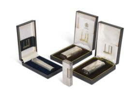 A group of four Dunhill electroplate pocket lights, three boxed,