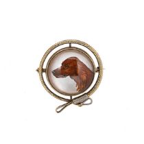 A reverse painted crystal intaglio brooch,