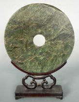 A Chinese dark green jade bi-disc,