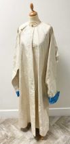 A Chinese ivory silk brocade long jacket, early 20th century,