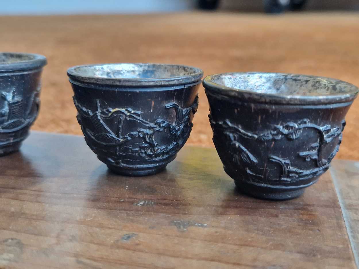 A set of eight Chinese export carved and silver mounted coconut wood wine cups, Qing Dynasty, early - Image 6 of 20