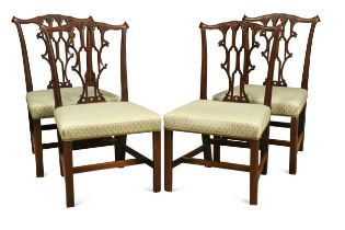 A set of four George III mahogany dining chairs,
