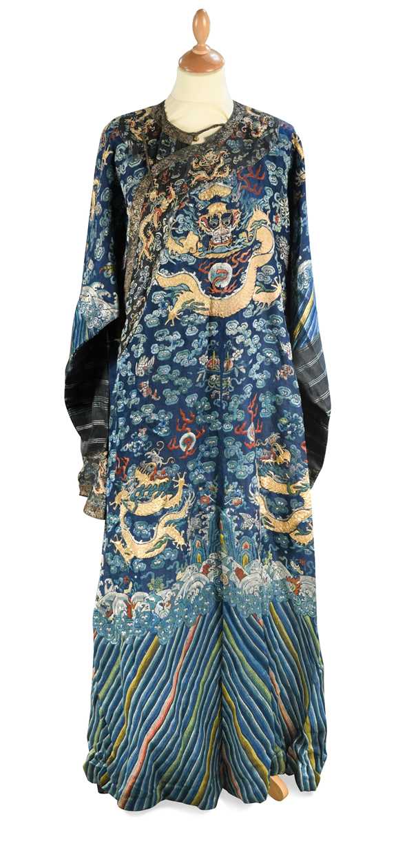 A Chinese embroidered silk blue ground dragon robe, late Qing Dynasty,